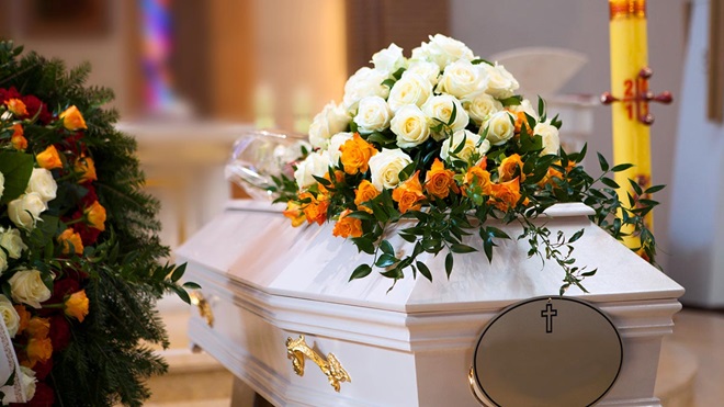 lots of flowers on a coffin at a funeral the hidden costs of a funeral